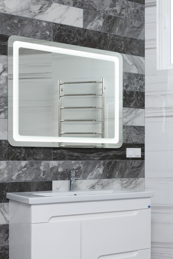 About Contemporary bathroom with stainless steel tap and washstand under mirror reflecting metal rack in house